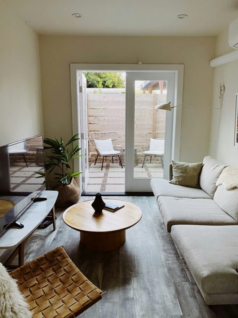 Wooden round table near white couch